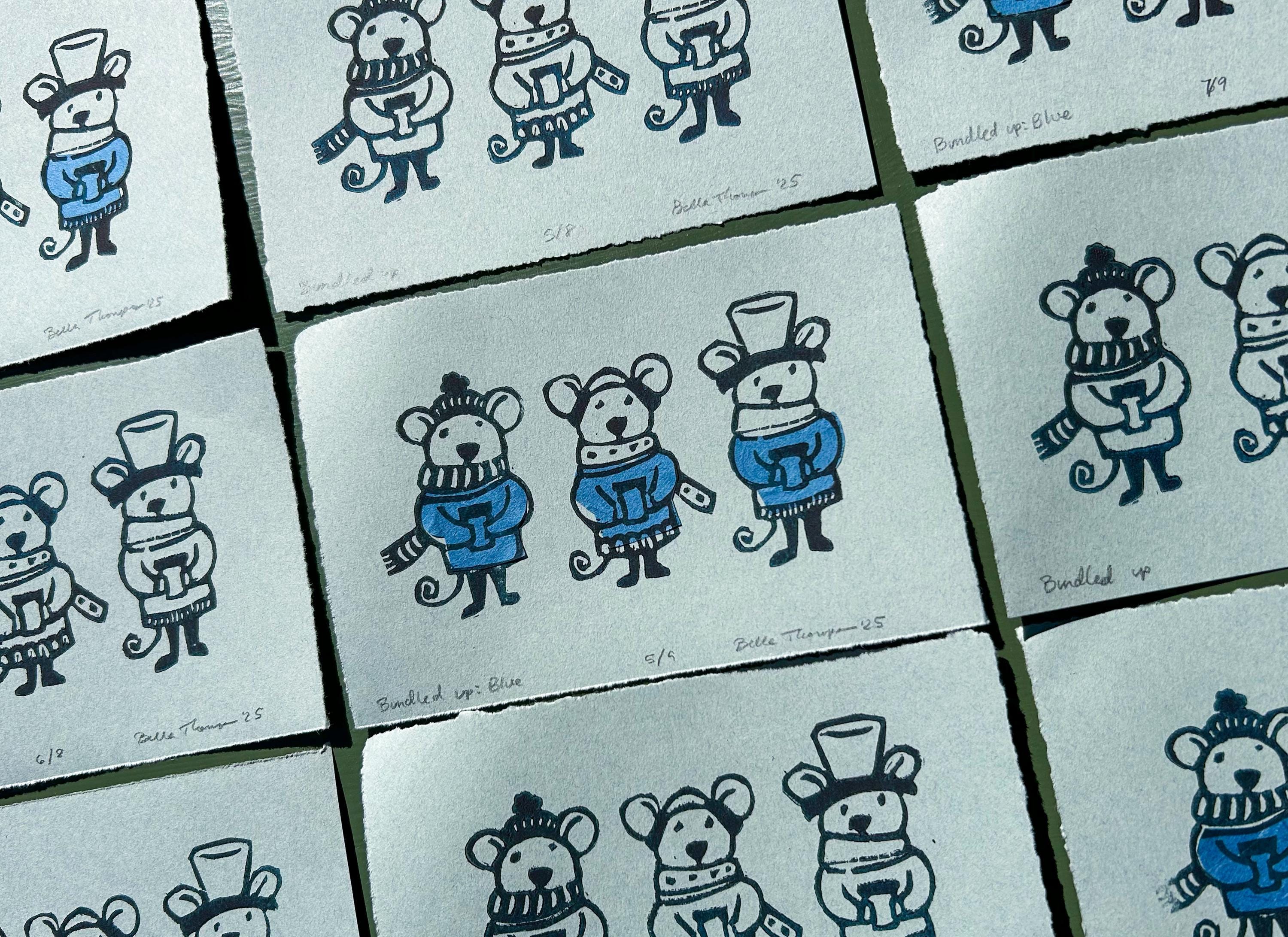 Winter mice with blue coats holding hot chocolate. Chine collé used to create the blue sweaters patterned prints making the backgorund on heavyweight paper signed by artist. Linocut prints