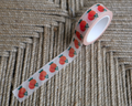 linocut design of florida orange citrus with on decorative washi tape. unrolled showing the design on a textured brown background. by dovetail studio