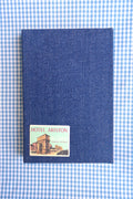 Denim textured reading log with a vintage roma patch on a blue and white checkered background