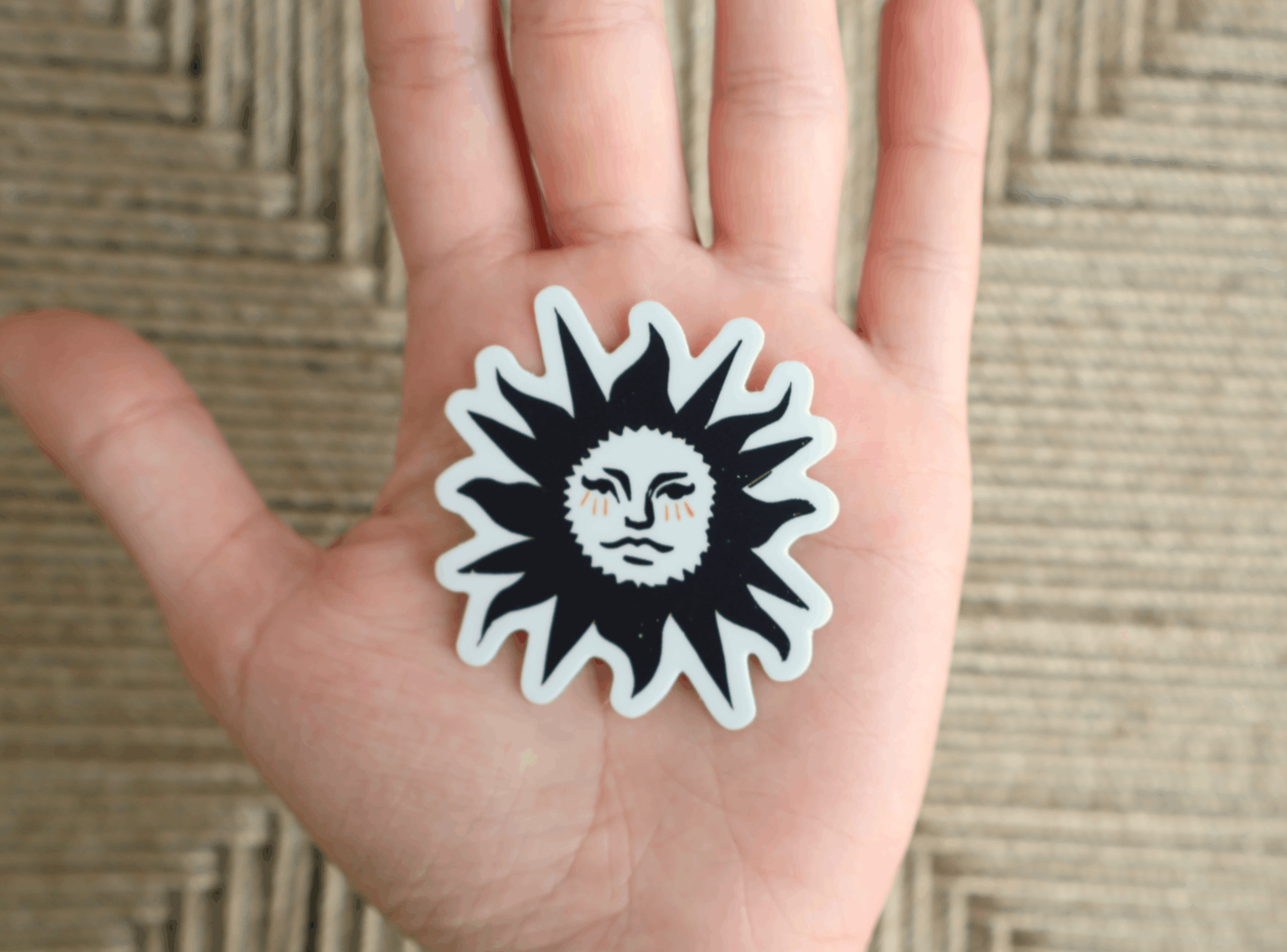 Diecut Linocut sunshine art sticker on hand with brown background