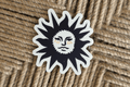 diecut linocut black and yellow sticker on brown background