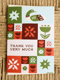 card on brown woven background that says thank you very much and has a heron and floral grid swiss folk motifs on it.