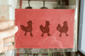 brown on red chicken with boots handmade linocut prints signed by artist layered in background