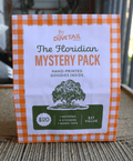 floridian linocut mystery pack green and orange on brown woven background table