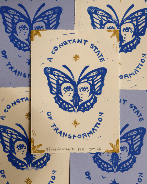 handmade linocut print with butterfly design and text 'A Constant State of Transformation' on a patterned background.