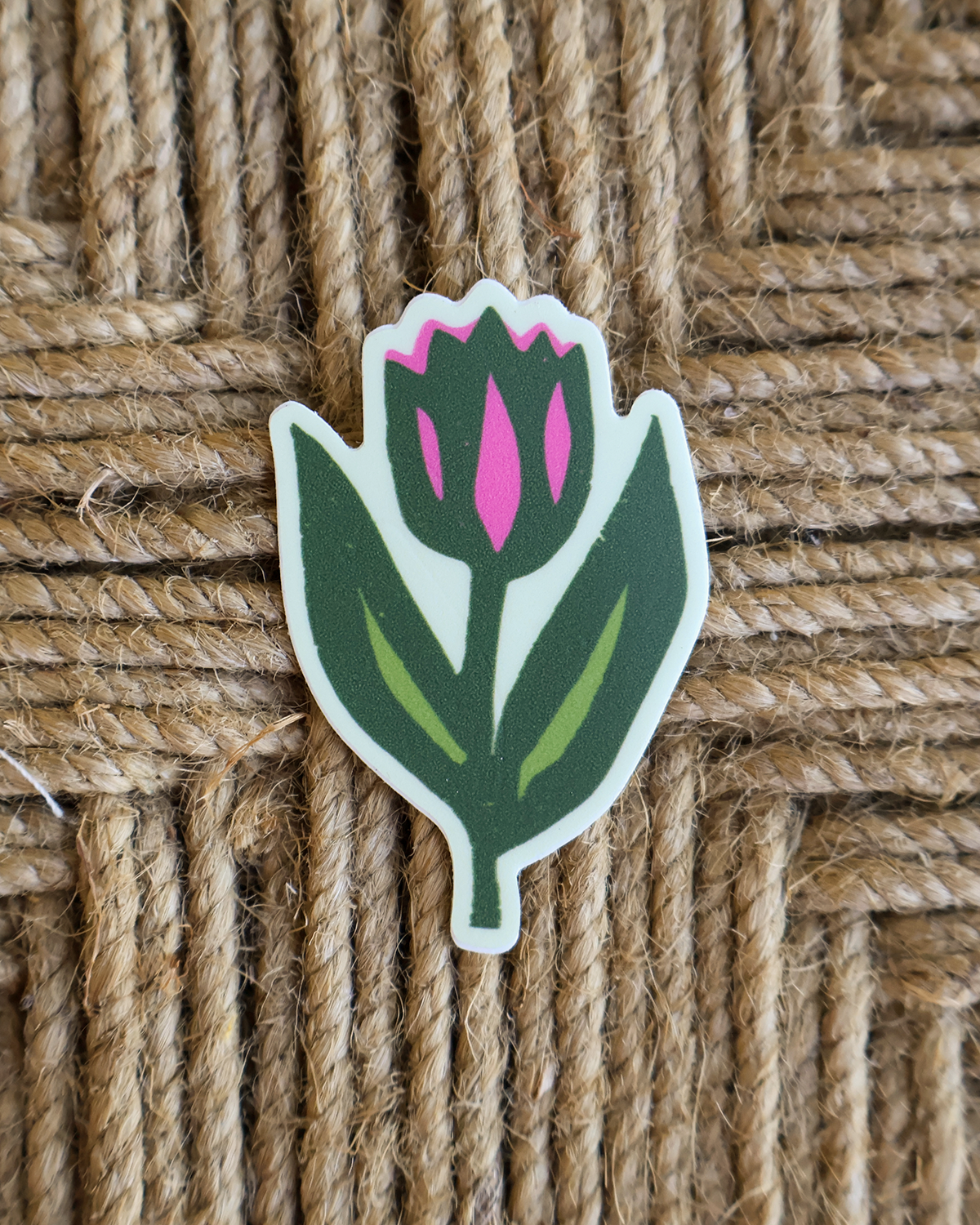 pink and green tulip waterproof vinyl sticker from an original linocut design on a textured brown background