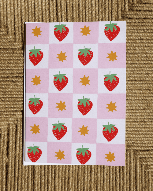 greeting card with strawberry pattern on a textured brown surface made from an original linocut design with envelope included