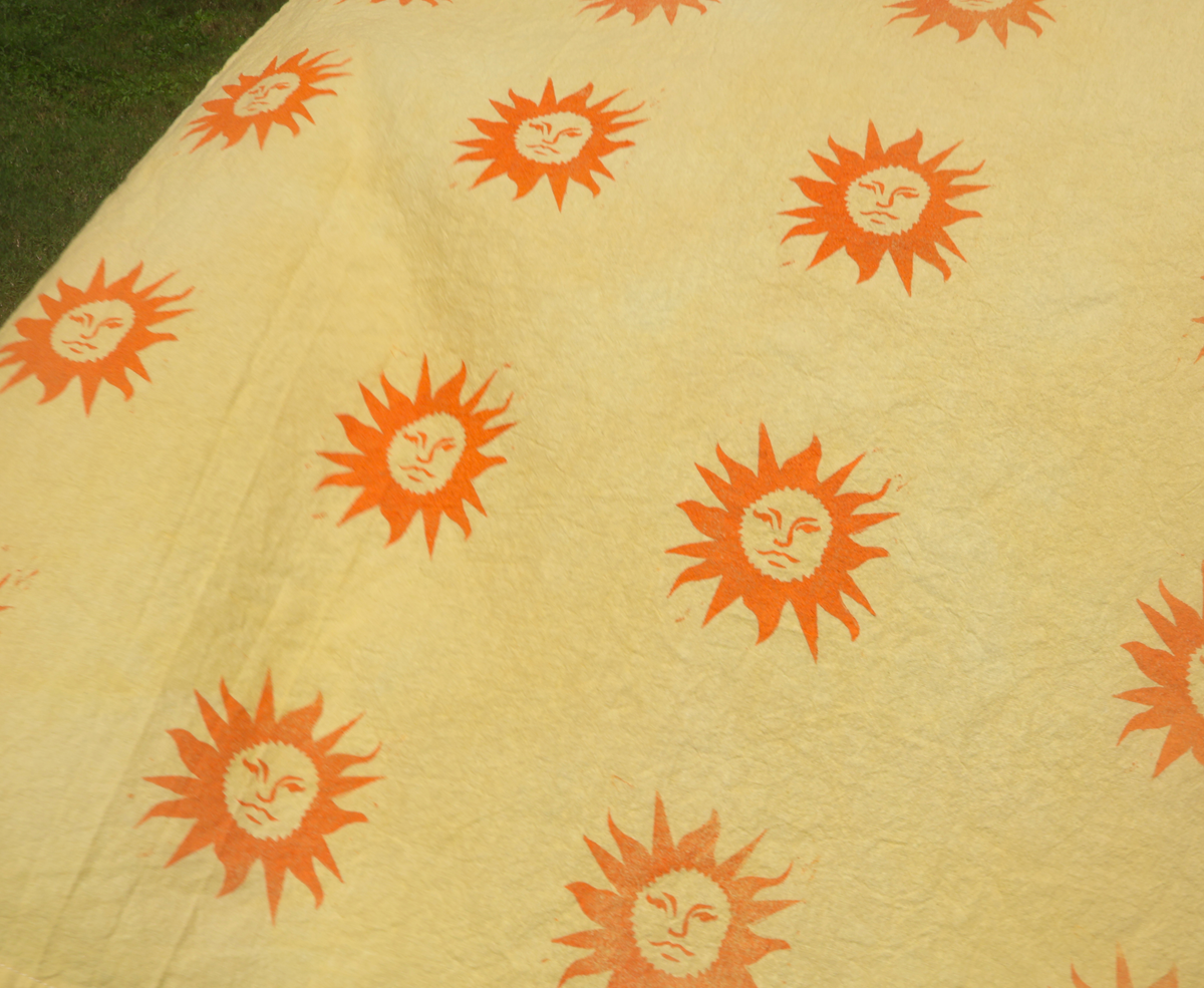linocut sunshine on yellow teatowel